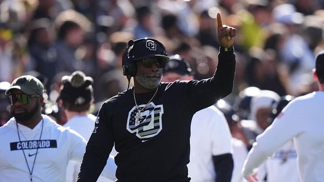 Colorado Buffaloes head coach Deion Sanders calls in a play in the first quarter against the Utah Utes at Folsom Field.