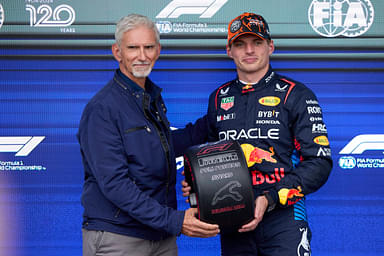 F1 Grand Prix of Hungary - Qualifying Max Verstappen of the Netherlands and Oracle Red Bull Racing receives the poleman award from Damon Hill in the parc ferme after the qualifying ahead of the F1 Grand Prix of Belgium at Circuit de Spa-Francorchamps