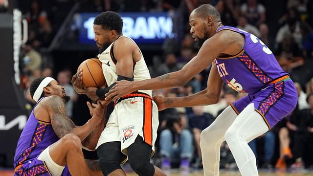 Phoenix Suns guard Bradley Beal (3) and Phoenix Suns forward Kevin Durant (35) attempt to tie up Detroit Pistons guard Malik Beasley (5) during the second half at Footprint Center.