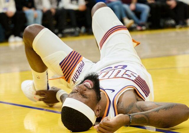 Phoenix Suns forward Ryan Dunn (0) reacts with an apparent injury against the Golden State Warriors during the second quarter at Chase Center.