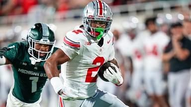 Sep 28, 2024; East Lansing, Michigan, USA; Ohio State Buckeyes wide receiver Emeka Egbuka (2) runs the ball against Michigan State Spartans defensive back Nikai Martinez (1) in the second half at Spartan Stadium on Saturday.