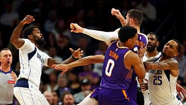 Dallas Mavericks forward Naji Marshall (13) punches Phoenix Suns center Jusuf Nurkic (20) during the third quarter at Footprint Center.