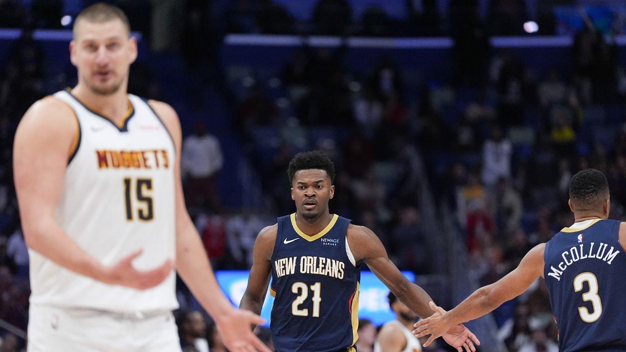 New Orleans Pelicans center Yves Missi (21) celebrates a basket with New Orleans Pelicans guard CJ McCollum (3) as Denver Nuggets center Nikola Jokic (15) reacts during overtime at Smoothie King Center.