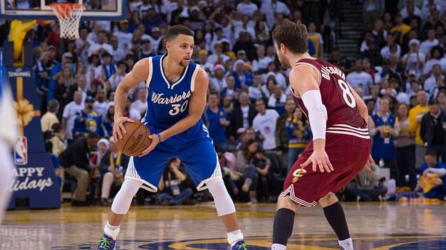 Golden State Warriors guard Stephen Curry (30) controls the basketball against Cleveland Cavaliers guard Matthew Dellavedova (8) during the fourth quarter in a NBA basketball game on Christmas at Oracle Arena. The Warriors defeated the Cavaliers 89-83.