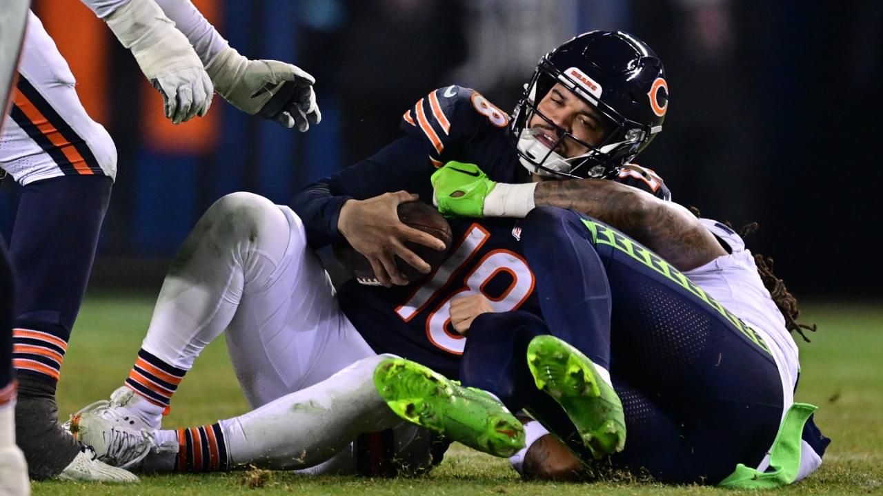 Dec 26, 2024; Chicago, Illinois, USA; Chicago Bears quarterback Caleb Williams (18) is sacked by Seattle Seahawks defensive back Rayshawn Jenkins (2) during the fourth quarter at Soldier Field.