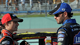 NASCAR Sprint Cup Series drivers Jeff Gordon (left) talks to Jimmie Johnson (right) during qualifying for the Ford 400 at Homestead Miami Speedway.