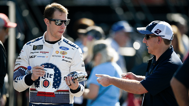 Monster Energy NASCAR Cup Series driver Brad Keselowski (2) autographs a fan's miniature car during practice for the Can-Am 500 at ISM Raceway.