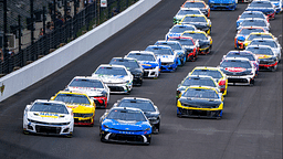 Cars race into turn one during a restart of the 30th running of the Brickyard 400, Sunday, July 21, 2024, at Indianapolis Motor Speedway.