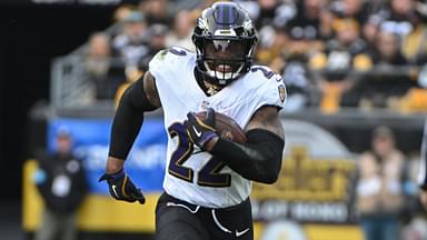 Nov 17, 2024; Pittsburgh, Pennsylvania, USA; Baltimore Ravens running back Derrick Henry (22) gains yardage while being chased by Pittsburgh Steelers linebacker T.J. Watt (90) during the second quarter at Acrisure Stadium.