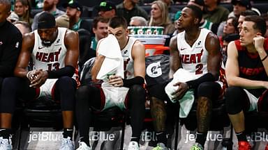 Miami Heat players (left to right) center Bam Adebayo (13), guard Tyler Herro (14), guard Terry Rozier (2) and forward Duncan Robinson (55) sit on the bench during the fourth quarter of their loss to the Boston Celtics at TD Garden.