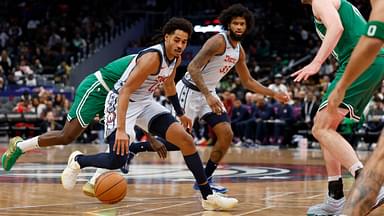 Washington Wizards guard Jordan Poole (13) dribbles the ball as Boston Celtics center Luke Kornet (40) defends in the third quarter at Capital One Arena.