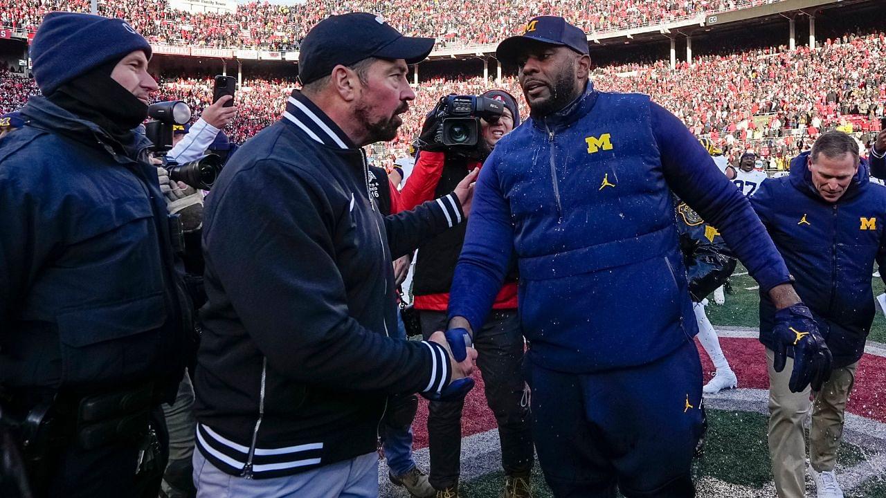 Ohio State Buckeyes head coach Ryan Day shakes hands with Michigan Wolverines head coach Sherrone Moore following the NCAA football game at Ohio Stadium in Columbus on Saturday, Nov. 30, 2024. Michigan won 13-10.