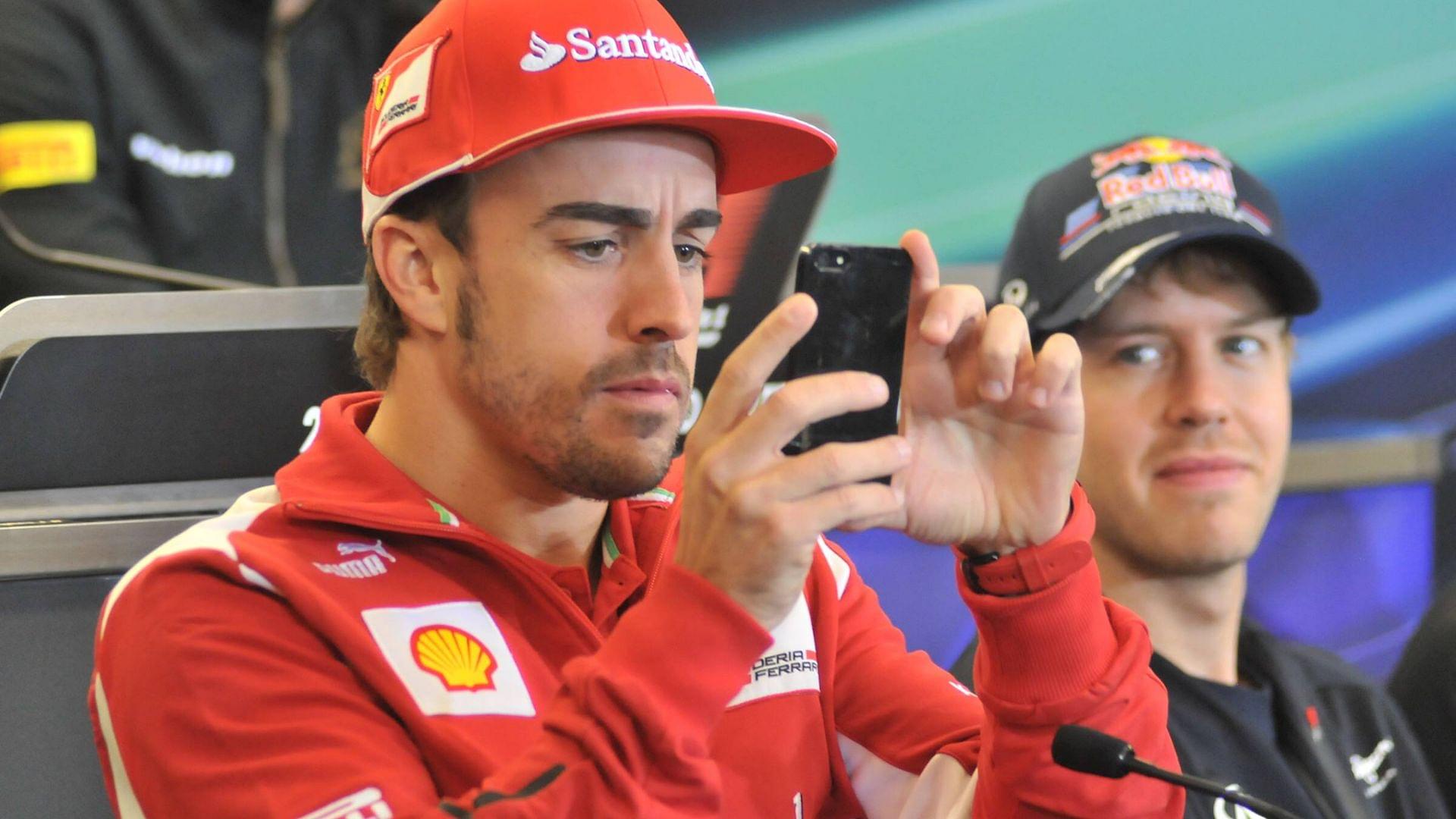 Nov. 15, 2012 - Austin, Texas, USA - Formula 1 driver FERNANDO ALONSO (left) of Spain takes pictures of the media during a press conference at the Circuit of the America s in Austin, Texas