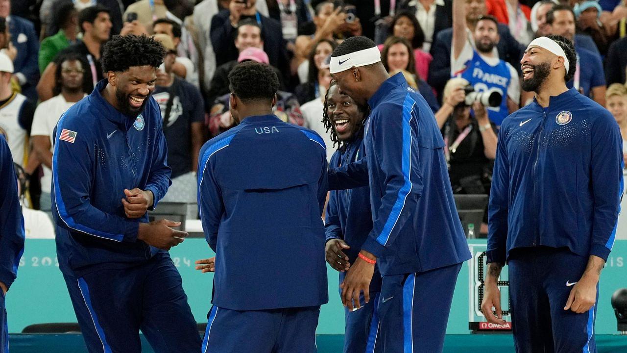 United States centre Joel Embiid (11) and guard Anthony Edwards (5) and guard Jrue Holiday (12) and centre Bam Adebayo (13) and centre Anthony Davis (14) celebrate after defeating France in the men's basketball gold medal game during the Paris 2024 Olympic Summer Games at Accor Arena.