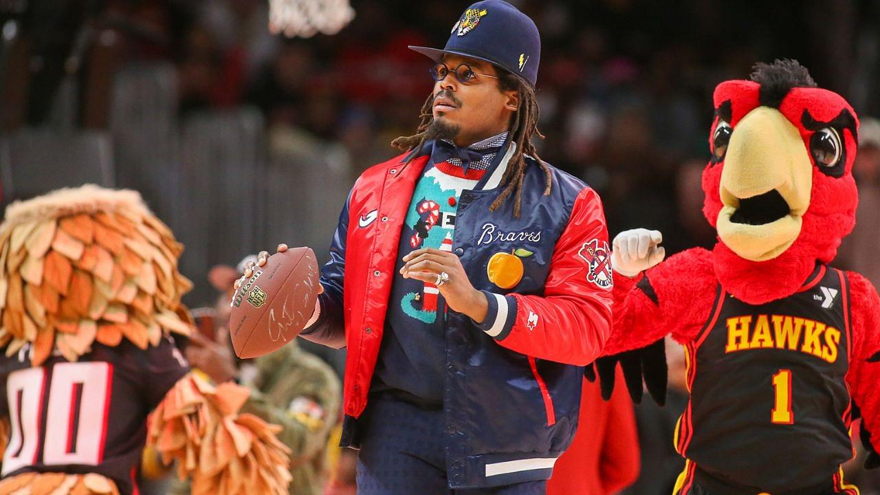 Former NFL quarterback Cam Newton on the court during a game between the Atlanta Hawks and Detroit Pistons in the second quarter at State Farm Arena.