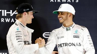 Mercedes Formula One driver Nico Rosberg (L) of Germany shakes hands with Lewis Hamilton of Britain