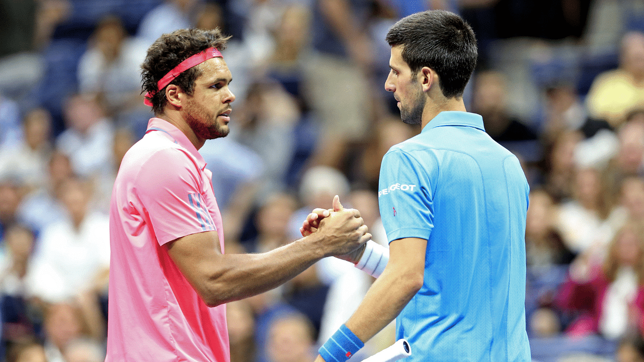 Jo-Wilfried Tsonga of France shakes hands with Novak Djokovic of Serbia after the match on day nine of the 2016 U.S. Open