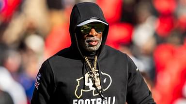 Colorado head coach Deion Sanders watches his players warmup prior to the game between the Kansas Jayhawks and the Colorado Buffaloes at GEHA Field at Arrowhead Stadium.