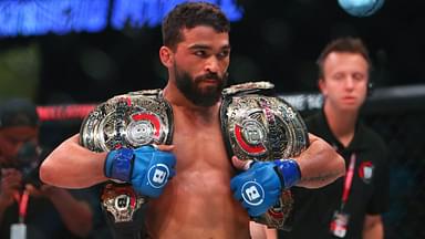 Patricio Freire (blue gloves) celebrates with his championship belts after defeating Michael Chandler (red gloves) during Bellator 221 at Allstate Arena.