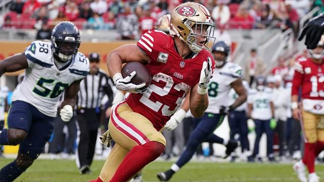 Nov 17, 2024; Santa Clara, California, USA; San Francisco 49ers running back Christian McCaffrey (23) rushes the ball while be pursued by Seattle Seahawks linebacker Derick Hall (58) in the fourth quarter at Levi's Stadium.