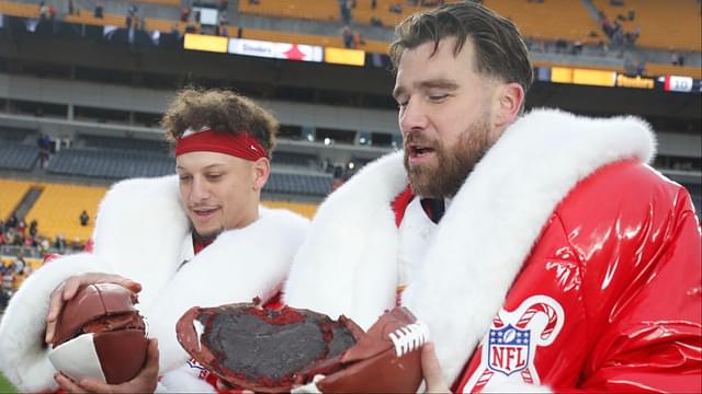 Kansas City Chiefs quarterback Patrick Mahomes (left) and tight end Travis Kelce (right) open their Netflix Christmas GameDay cake after the Chiefs defeated the Pittsburgh Steelers at Acrisure Stadium.