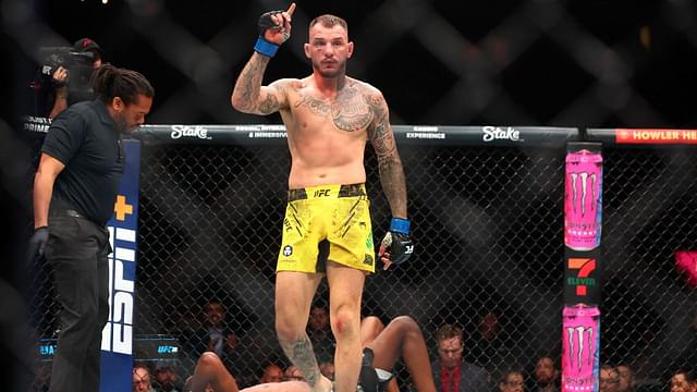 Renato Moicano (blue gloves) reacts after defeating Jalin Turner (red gloves) during UFC 300 at T-Mobile Arena.