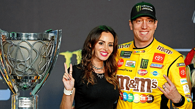 Nov 17, 2019; Homestead, FL, USA; NASCAR Cup Series driver Kyle Busch (18) celebrates after winning the NASCAR Series Cup Championship with his wife Samantha Busch after the Ford EcoBoost 400 at Homestead-Miami Speedway. Mandatory Credit: John David Mercer-Imagn Images