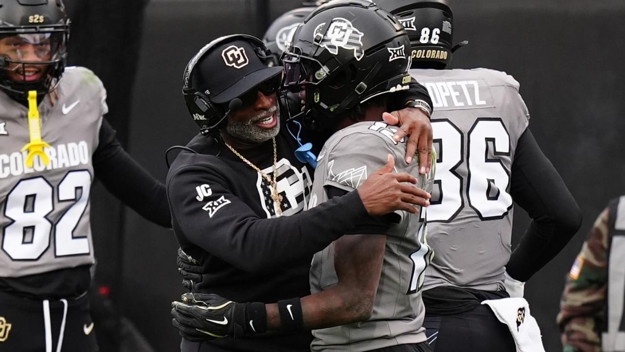 Nov 16, 2024; Boulder, Colorado, USA; Colorado Buffaloes head coach Deion Sanders hugs wide receiver Travis Hunter (12) following a touchdown in the fourth quarter against the Utah Utes at Folsom Field.