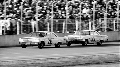 DAYTONA BEACH - FEBRUARY 24: Cars race past the grandstands during the Daytona 500, Daytona Beach, Florida, February 24, 1963. American driver Fred Lorenzen is in car #28, while Ned Jarrett drives #11. Michael Rougier/The LIFE Picture Collection