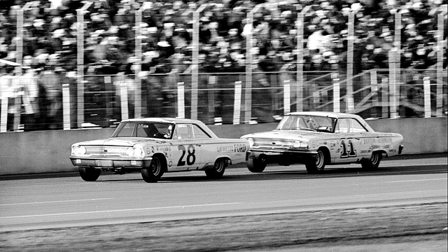 DAYTONA BEACH - FEBRUARY 24: Cars race past the grandstands during the Daytona 500, Daytona Beach, Florida, February 24, 1963. American driver Fred Lorenzen is in car #28, while Ned Jarrett drives #11. Michael Rougier/The LIFE Picture Collection