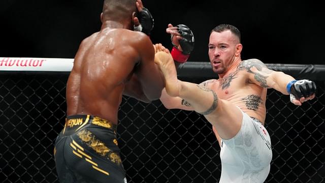 Leon Edwards (red gloves) fights Colby Covington (blue gloves) during UFC 296 at T-Mobile Arena.