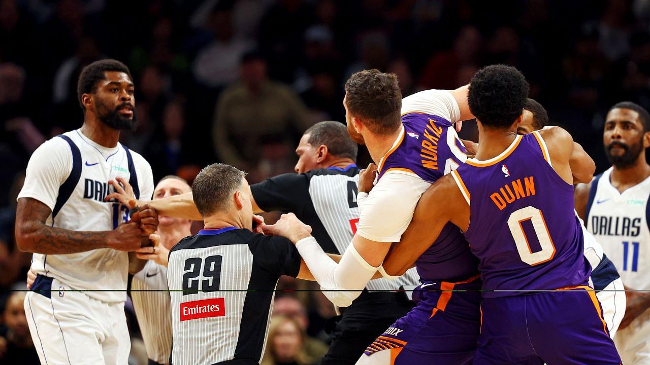 Dallas Mavericks forward Naji Marshall (13) punches Phoenix Suns center Jusuf Nurkic (20) during the third quarter at Footprint Center.