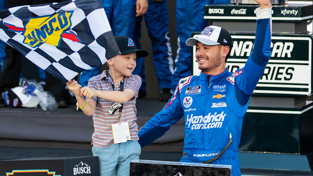 Nov 7, 2021; Avondale, Arizona, USA; NASCAR Cup Series driver Kyle Larson (5) celebrates with son Owen Larson after winning the 2021 NASCAR Cup Series Championship at Phoenix Raceway. Mandatory Credit: Mark J. Rebilas-Imagn Images