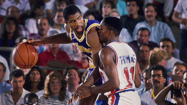 Los Angeles Lakers guard Magic Johnson (32) is defended by Detroit Pistons guard Isiah Thomas (11) at the Silverdome.