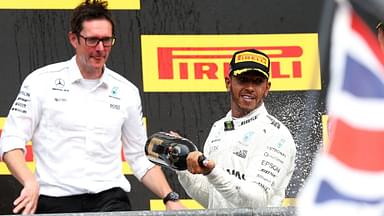 Mercedes Lewis Hamilton celebrates with champagne alongside Mercedes F1 Engineer Andrew Shovlin after victory in the 2017 Belgian Grand Prix