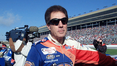 Darrell Waltrip munches on an energy bar before the start of his final NASCAR race after 28 years of racing. The race is the NAPA 500 at the Atlanta Motor Speedway Nov. 20, 2000.