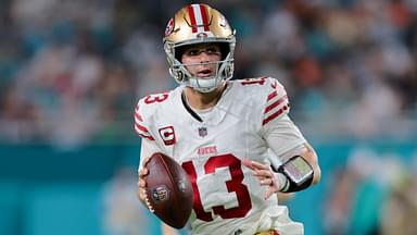 Dec 22, 2024; Miami Gardens, Florida, USA; San Francisco 49ers quarterback Brock Purdy (13) runs with the football against the Miami Dolphins during the fourth quarter at Hard Rock Stadium.