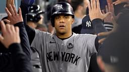 Oct 26, 2024; Los Angeles, California, USA; New York Yankees outfielder Juan Soto (22) celebrates in the dugout after scoring on an RBI single by designated hitter Giancarlo Stanton (not pictured) in the ninth inning against the Los Angeles Dodgers during game two of the 2024 MLB World Series at Dodger Stadium.