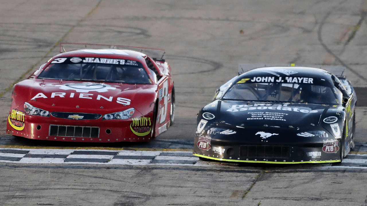 Sawyer Effertz, right, edges out Taylor Vandermoss in a Super Late Model qualifier during a night of championship racing including the Blue Race, the final leg of the Red, White and Blue State Championship Series