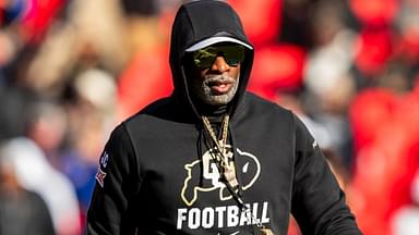 Kansas City, Missouri, USA; Colorado head coach Deion Sanders watches his players warmup prior to the game between the Kansas Jayhawks and the Colorado Buffaloes at GEHA Field at Arrowhead Stadium