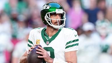 New York Jets quarterback Aaron Rodgers (8) passes against the Arizona Cardinals during the second half at State Farm Stadium.