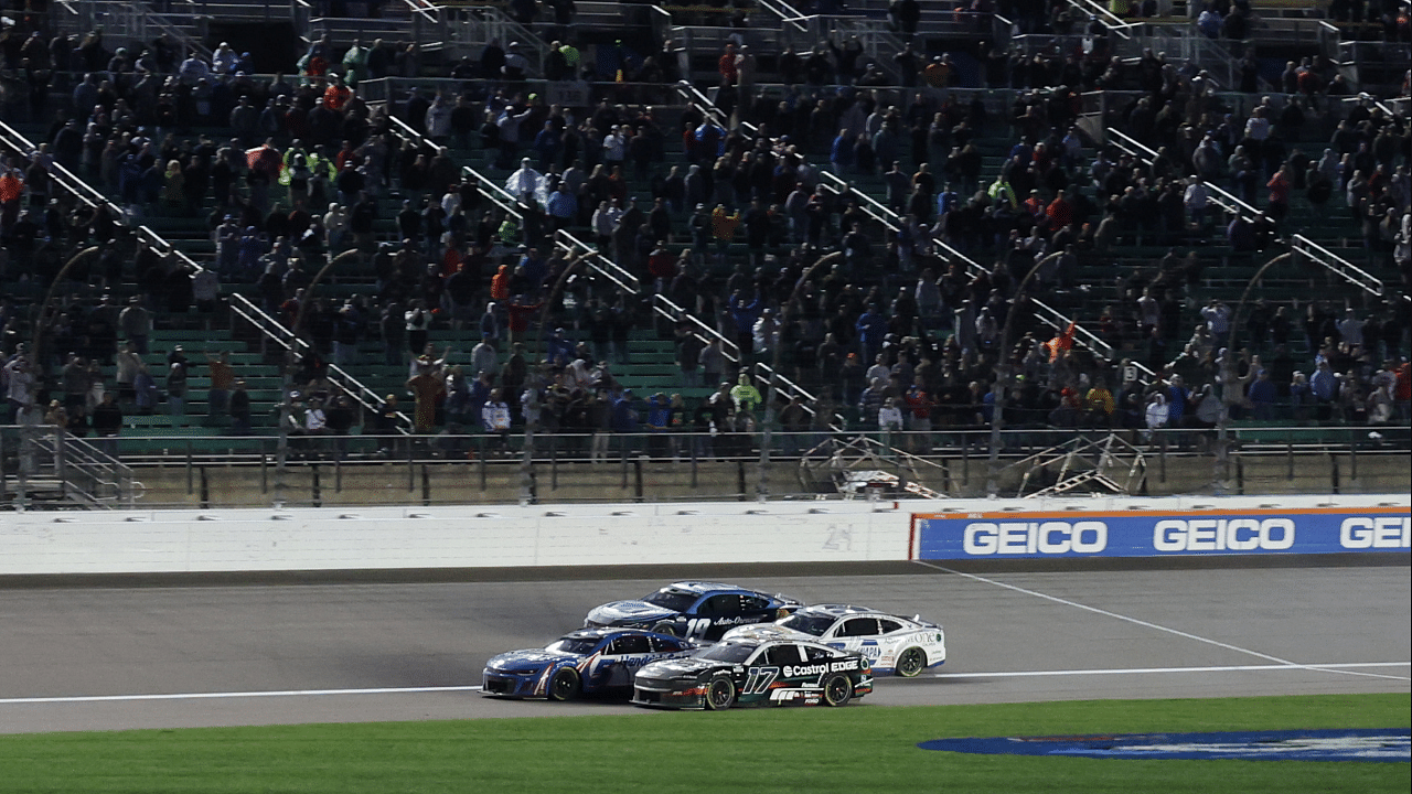 May 5, 2024; Kansas City, Kansas, USA; NASCAR Cup Series drivers Kyle Larson (5) and Chris Buescher (17) battle for the lead on the final lap off the Advent Health 400 at the Kansas Speedway. Mandatory Credit: Reese Strickland-Imagn Images