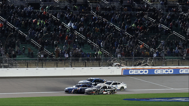 May 5, 2024; Kansas City, Kansas, USA; NASCAR Cup Series drivers Kyle Larson (5) and Chris Buescher (17) battle for the lead on the final lap off the Advent Health 400 at the Kansas Speedway. Mandatory Credit: Reese Strickland-Imagn Images