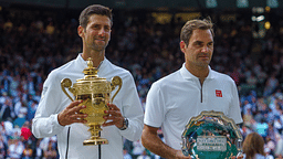 Novak Djokovic (SRB) poses with Roger Federer (SUI) after the mens final on day 13 at the All England Lawn