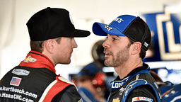 NASCAR Sprint Cup Series driver Jimmie Johnson (right) talks with Kurt Busch during practice for the Ford EcoBoost 400 at Homestead-Miami Speedway.