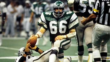 Philadelphia Eagles linebacker Bill Bergey (66) kneels over Oakland Raiders tight end Raymond Chester (88) in Super Bowl XV at the Superdome. The Raiders defeated the Eagles 27-10.