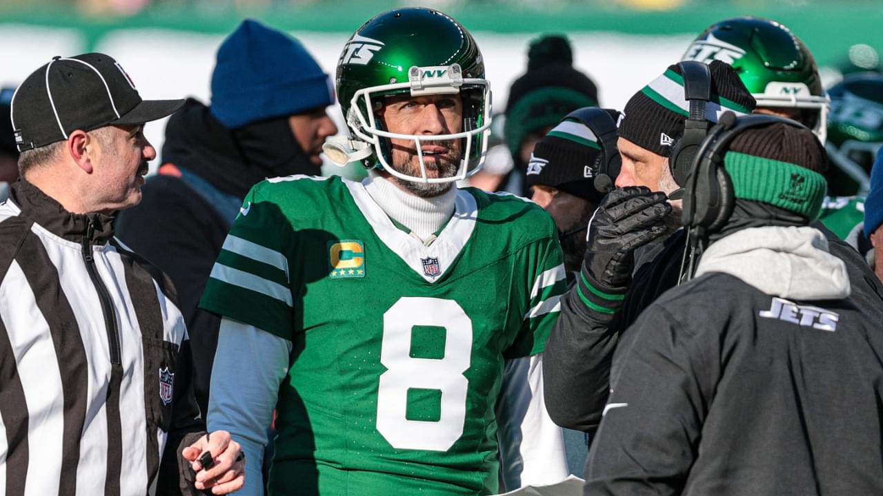 Dec 22, 2024; East Rutherford, New Jersey, USA; New York Jets quarterback Aaron Rodgers (8) talks with head coach Jeff Ulbrich during the first half against the Los Angeles Rams at MetLife Stadium.