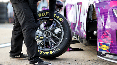 A crew member for NASCAR Cup Series driver Alex Bowman (48) puts a tire on the car during practice and qualifying for the Cook Out 400 at Richmond Raceway.