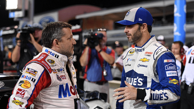 NASCAR Sprint Cup Series driver Tony Stewart (L) talks with NASCAR Sprint Cup Series driver Jimmie Johnson (R) during qualifying for the Ford Ecoboost 400 at Homestead-Miami Speedway.