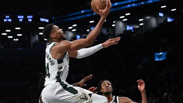 Milwaukee Bucks forward Giannis Antetokounmpo (34) drives to the basket while being defended by Brooklyn Nets forward Dorian Finney-Smith (28) and Brooklyn Nets center Nic Claxton (33) during the second half at Barclays Center.